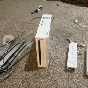 Nintendo wii, wii fit board, 2 nunchucks, 3 controls, wheel, and many games!